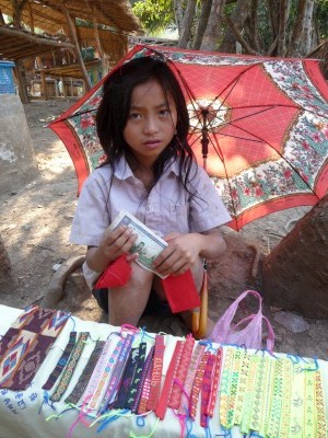 Girl selling trinkets by the road, laos Girl selling trinkets by the road